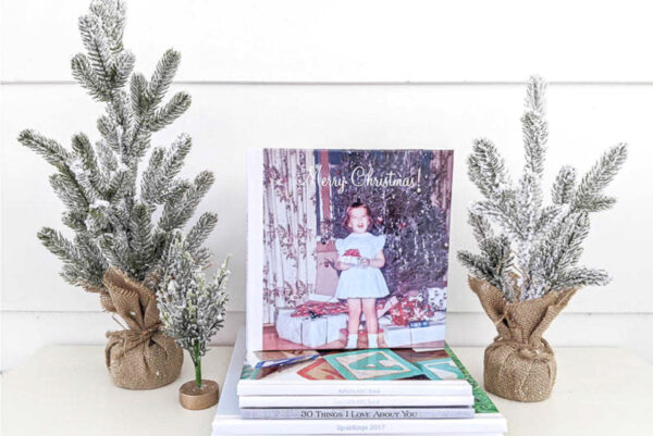 Christmas memories photo book next to mini Christmas trees.