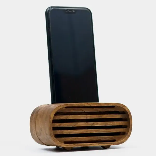smartphone sitting atop a wooden phone speaker.