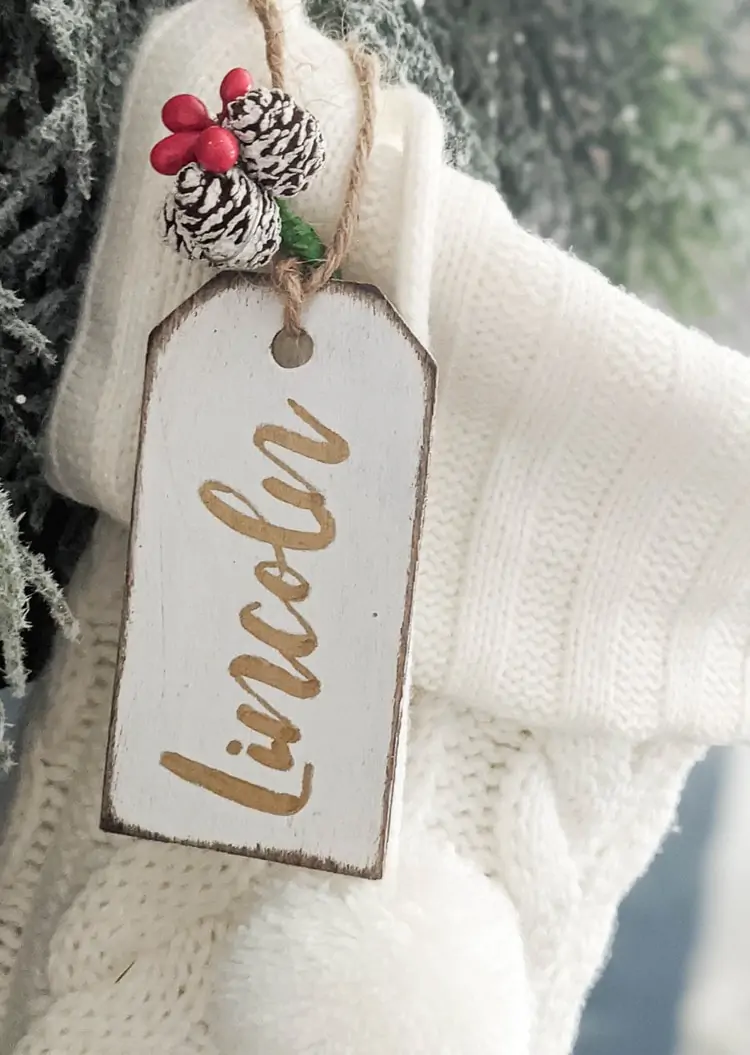 White stocking with diy stocking name tag with gold writing.