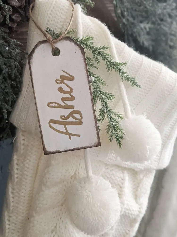 White stocking with diy stocking name tag with gold writing.