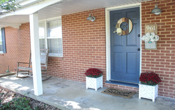 brick ranch with long concrete porch before makeover.