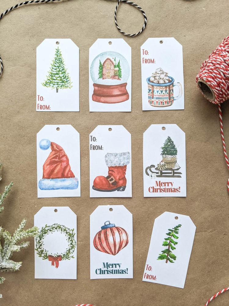 Set of Christmas gift tags with watercolor Christmas trees, snow globe, mug of cocoa, Santa hat, Santa boot, sled, wreath, and ornament.