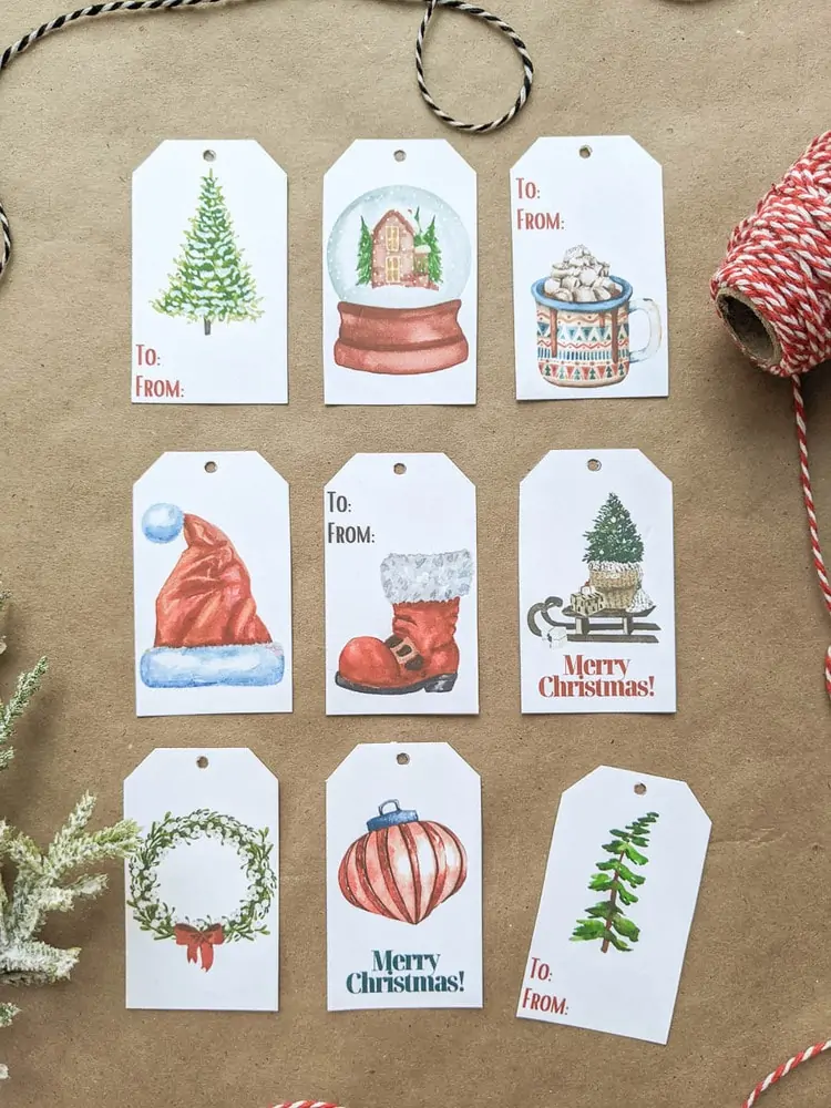 Set of Christmas gift tags with watercolor Christmas trees, snow globe, mug of cocoa, Santa hat, Santa boot, sled, wreath, and ornament.
