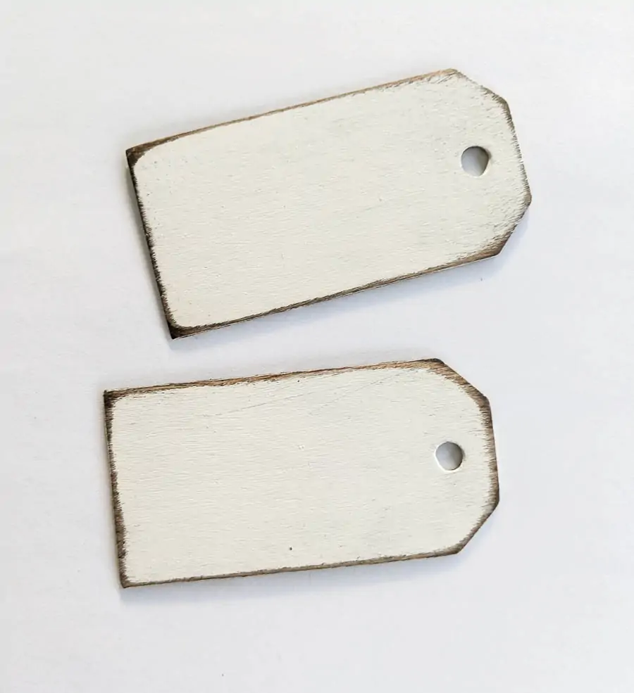 Wooden tags with distressed wood and white paint finish.