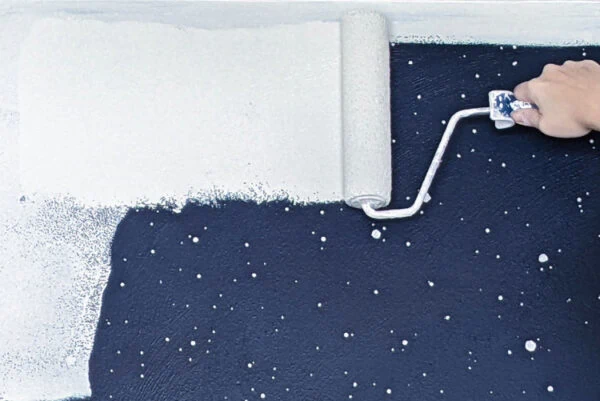 using paint roller to paint over dark walls