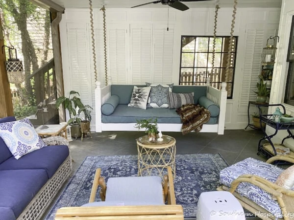 porch makeover with swing and ceiling fan.