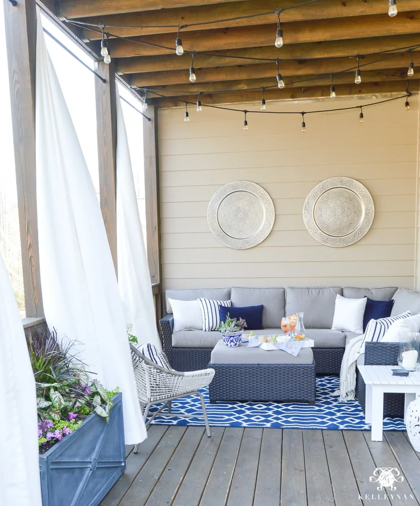 porch makeover with wood ceiling and string lights.