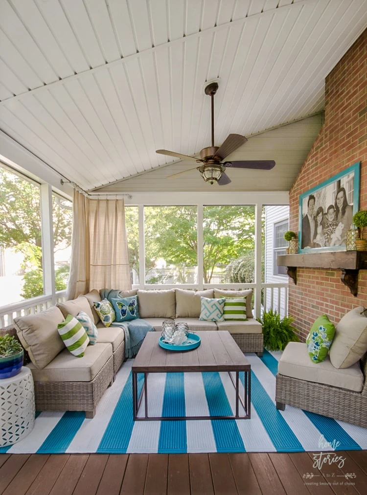 screen porch makeover with bright teal and white rug.