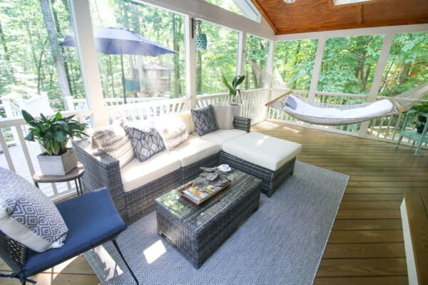 screened in porch with chaise lounge furniture.