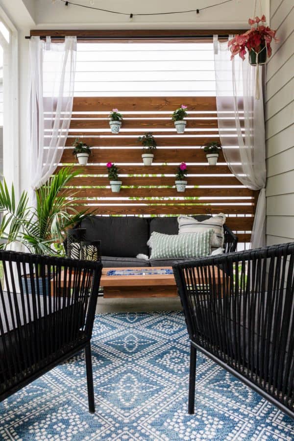 porch makeover with wood plant wall.