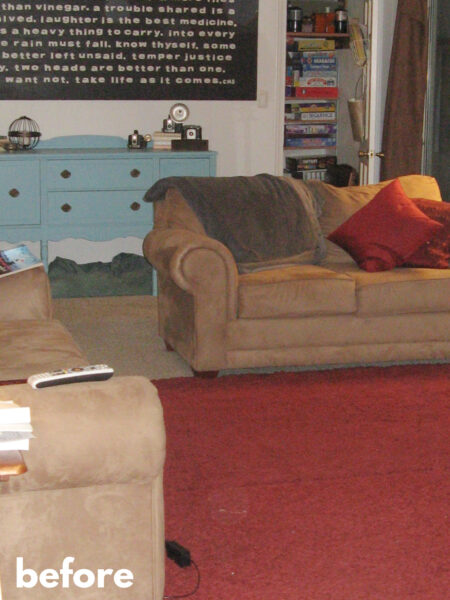 living room before photo with red rug, turquoise dresser, and tan sofas.