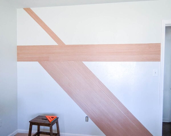 Horizontal and diagonal wood planks attached to wall.