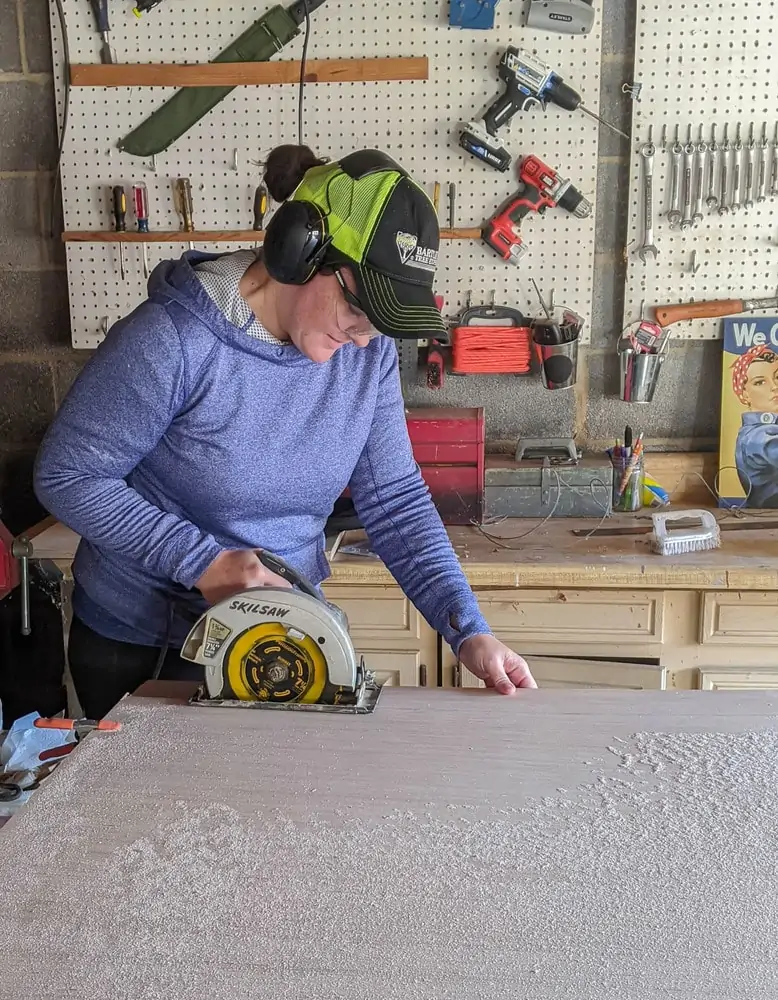 Cutting plywood into wood planks with a circular saw.