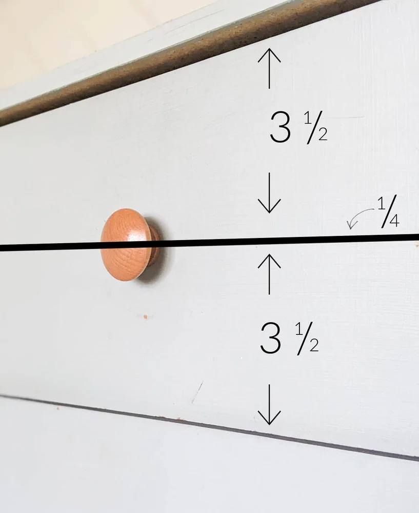 measuring the height of the drawer to determine the width of the wood planks.