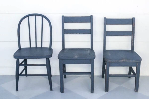 three small wooden chairs painted navy.