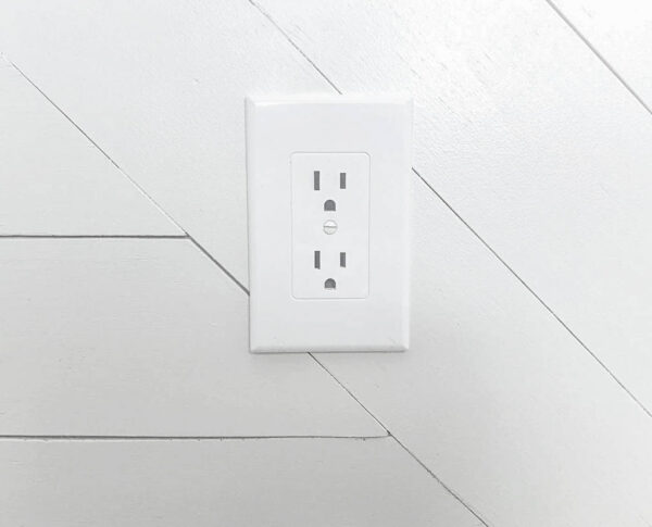 Revive outlet cover covering old electrical outlet.