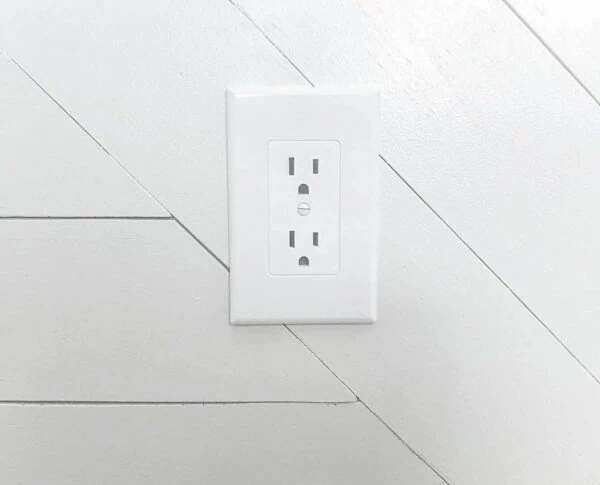Revive outlet cover covering old electrical outlet.