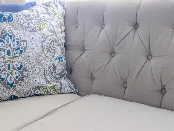 close up of sofa upholstered with drop cloth.