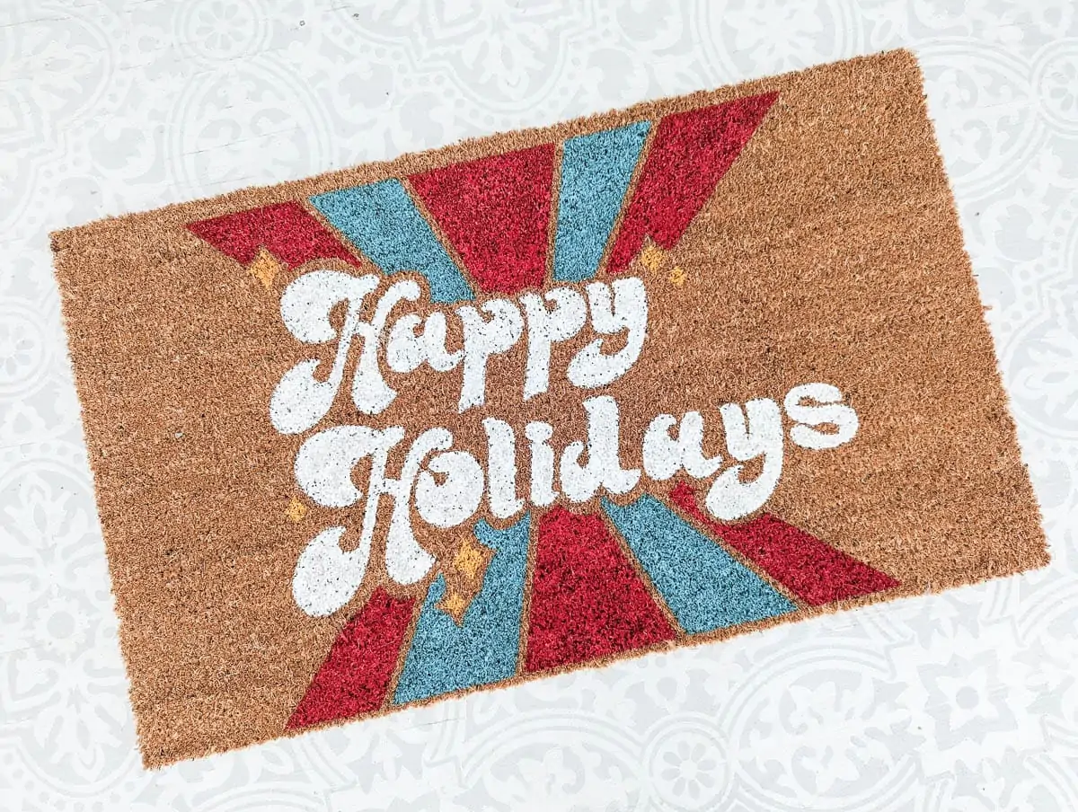 finished Christmas doormat against painted floor.