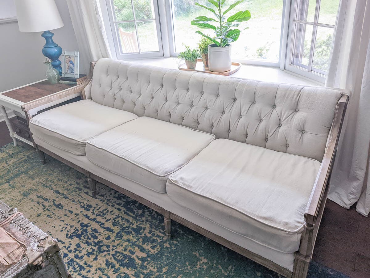 vintage sofa reupholstered with drop cloth after four years of use.