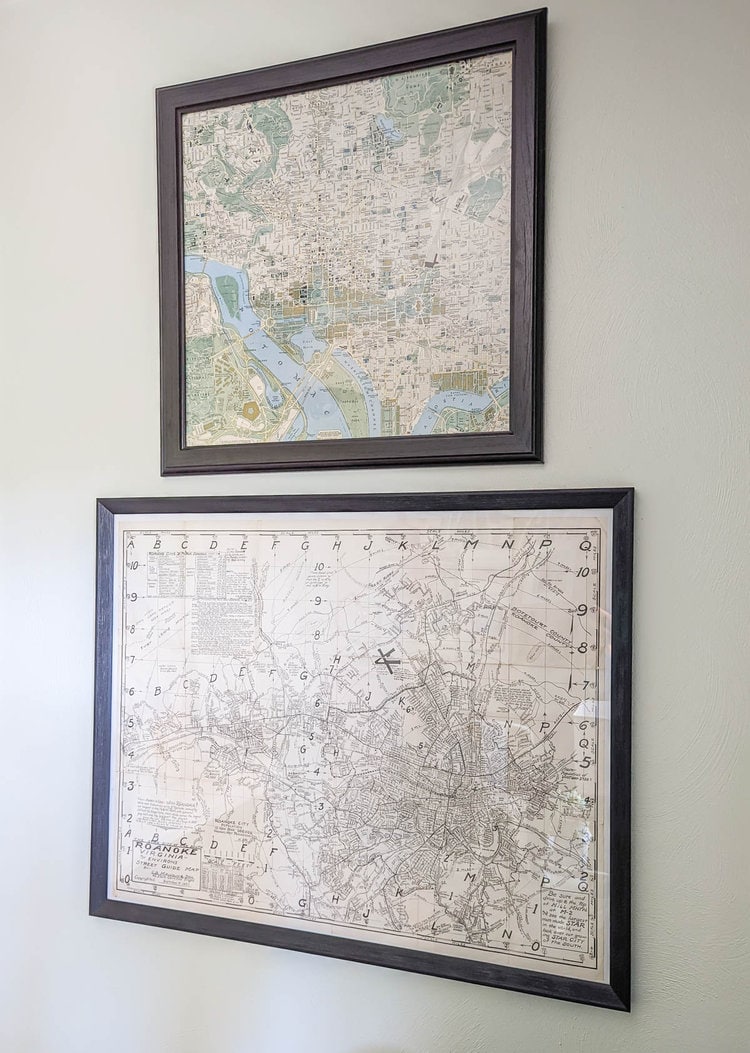 Two vintage maps framed on wall.