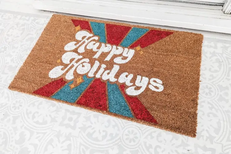diy christmas doormat in front of porch door.
