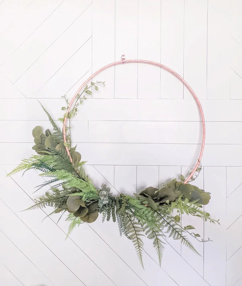 diy copper wreath against wood wall.