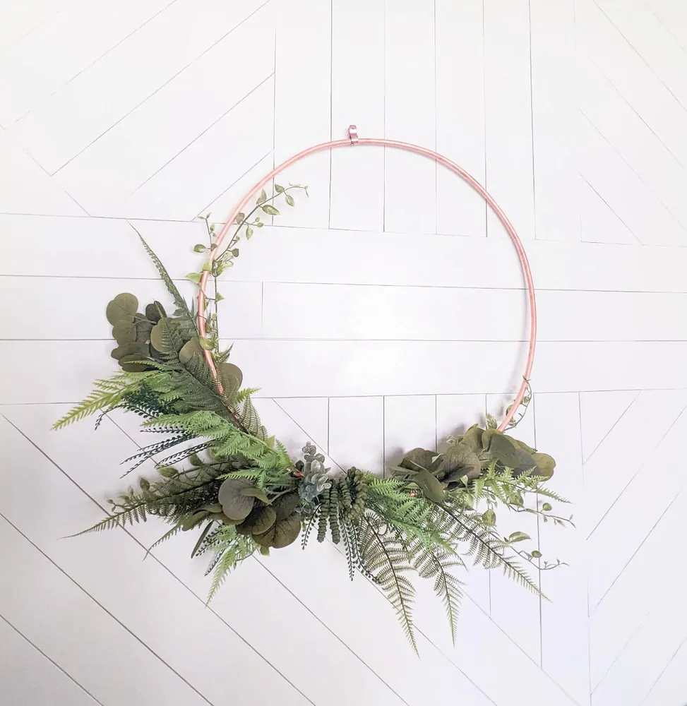 close up of diy copper wreath with greenery.