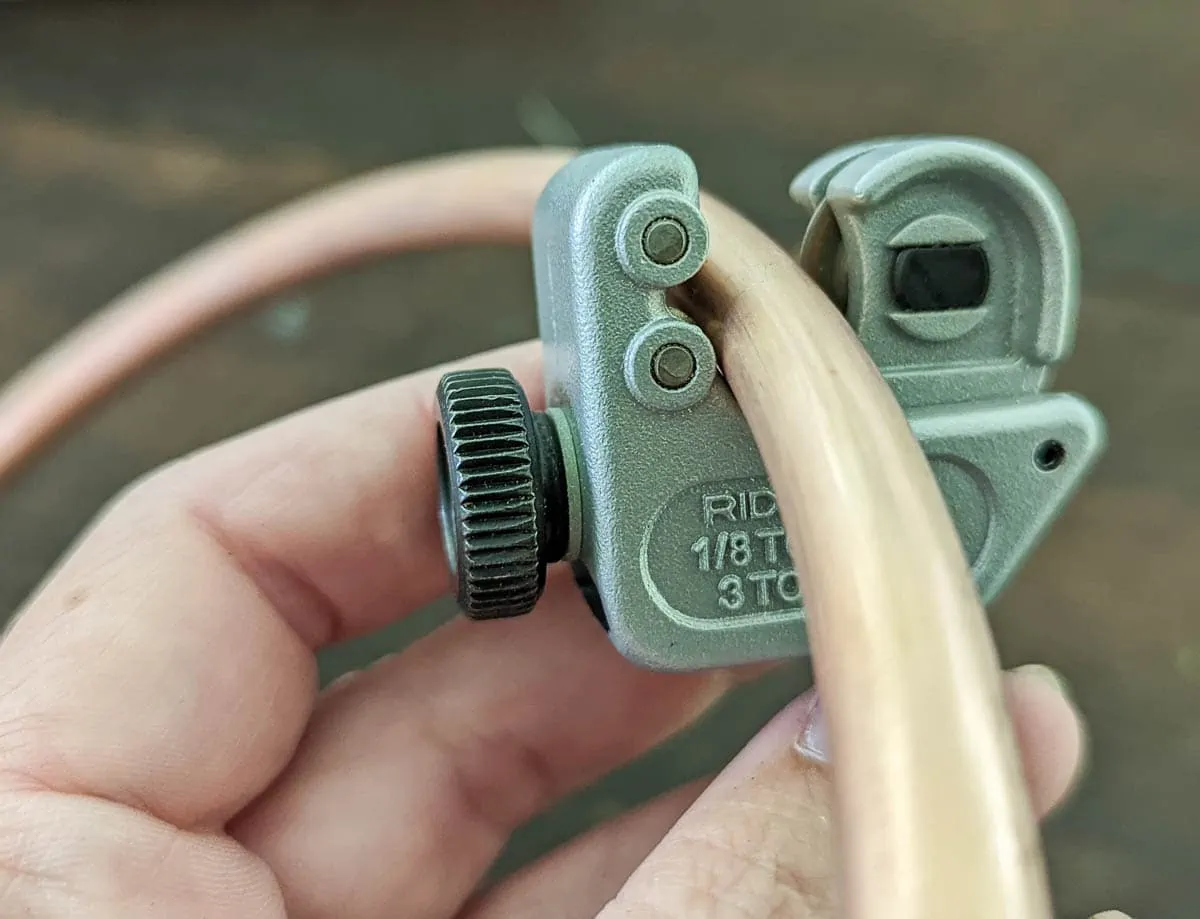 cutting copper tubing with a tubing cutter.