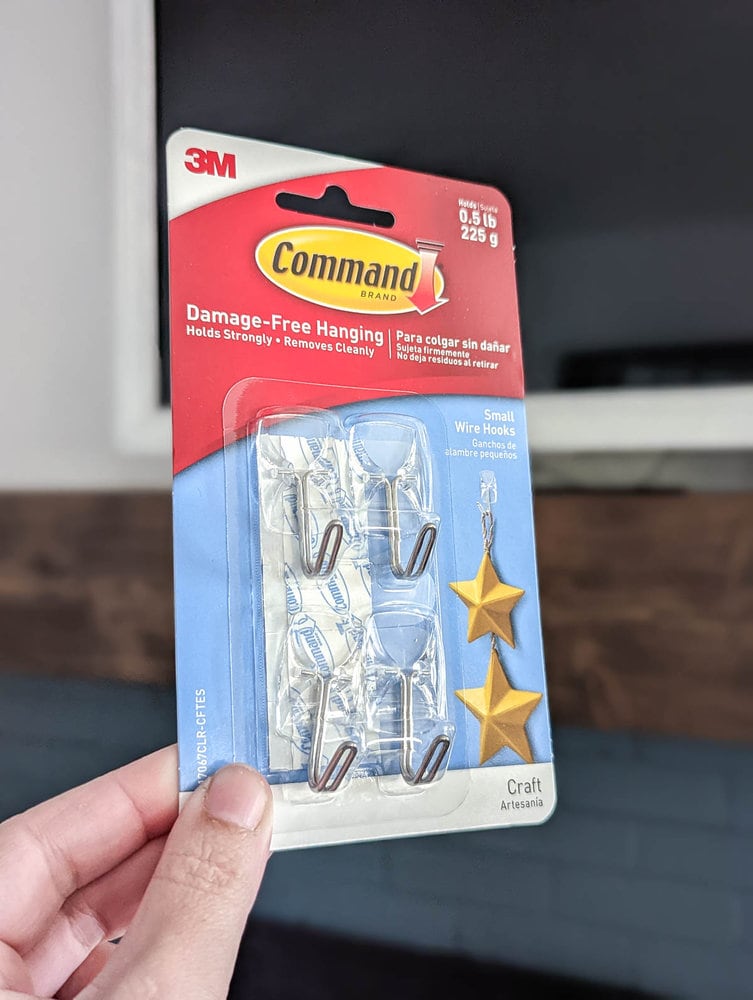 hang holding pack of clear command hooks.