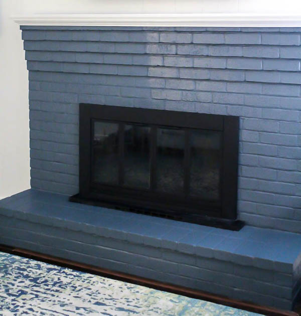 brick fireplace painted blue with half matte finish and half satin finish.