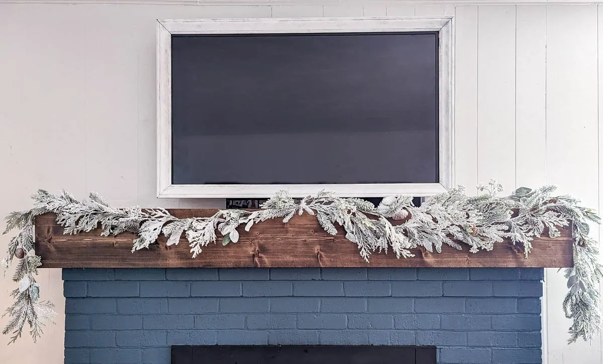 garland draped across mantel with one garland on half and two garlands on other half to show thickness.