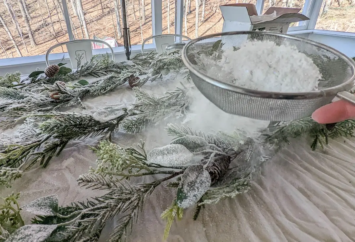 sifting flocking powder onto garland.