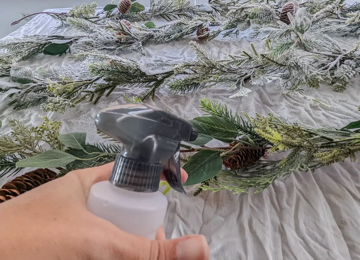 spraying water onto garland.