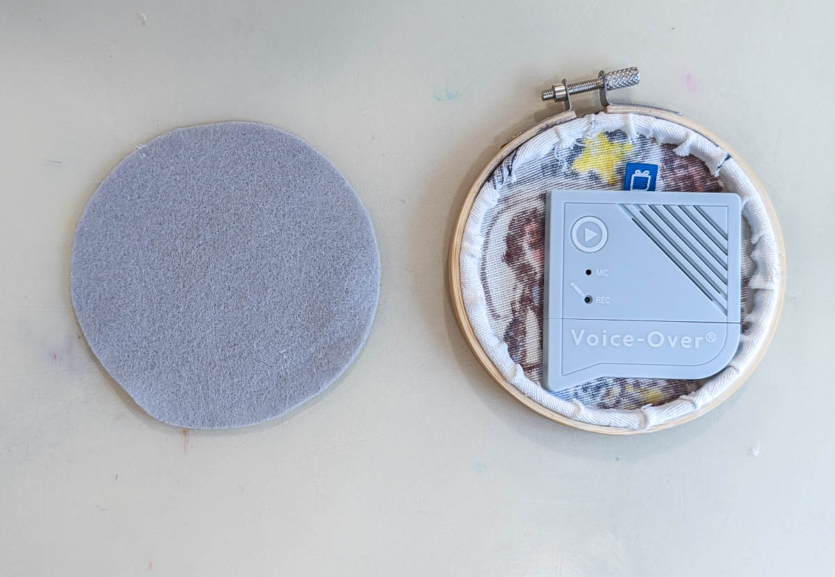 back of ornament with voice recorder attached next to circle of felt.