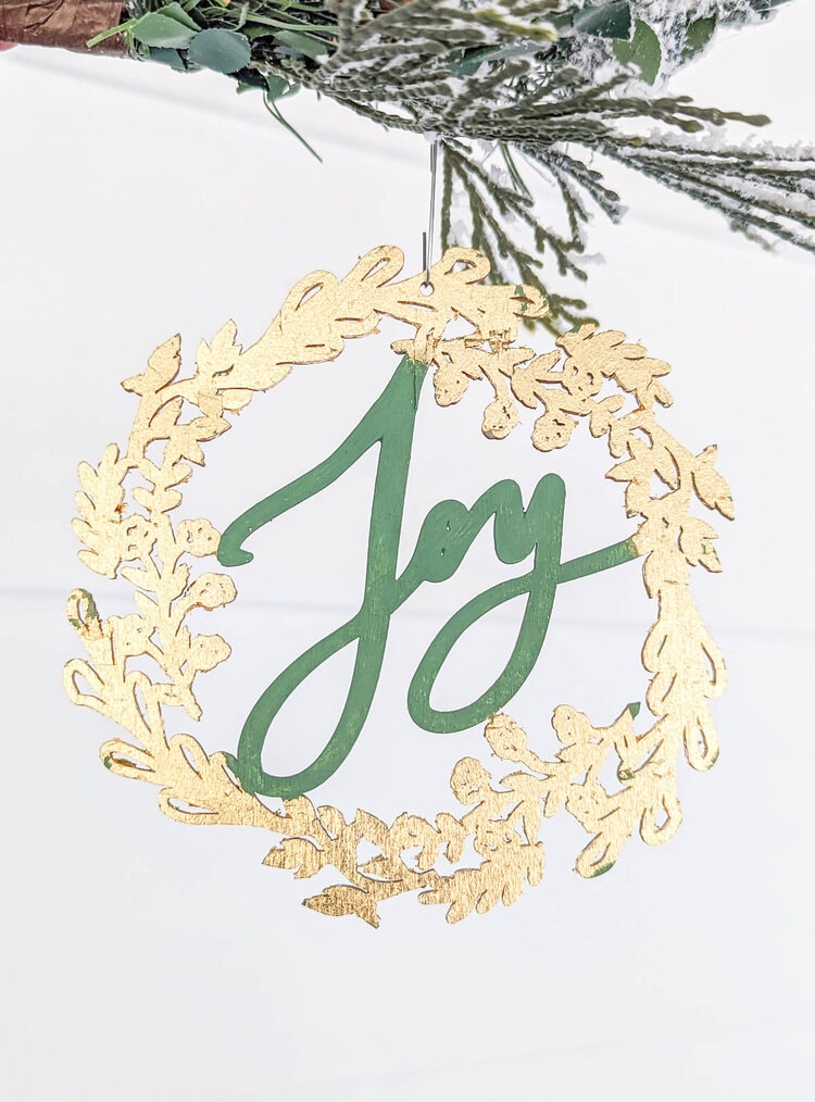Small wooden wreath cutout ornament covered in gold leaf.