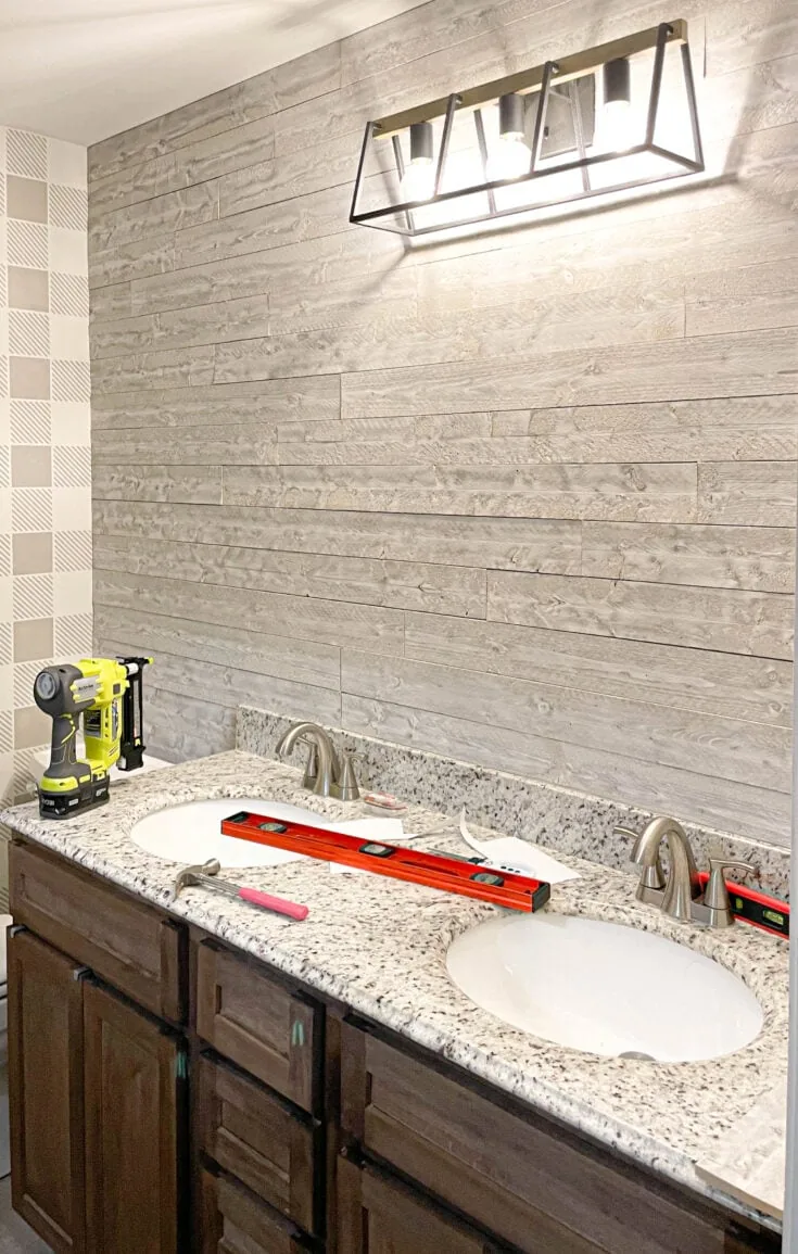 Bathroom with light gray wood wall using Rustix wood wall boards.