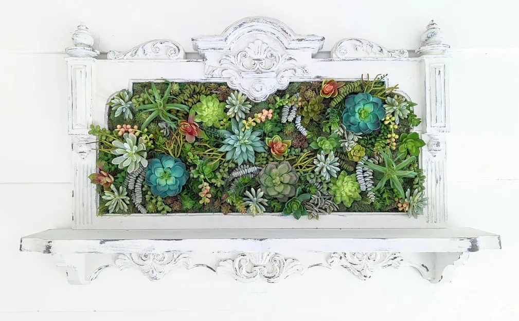 white framed faux succulent wall art.