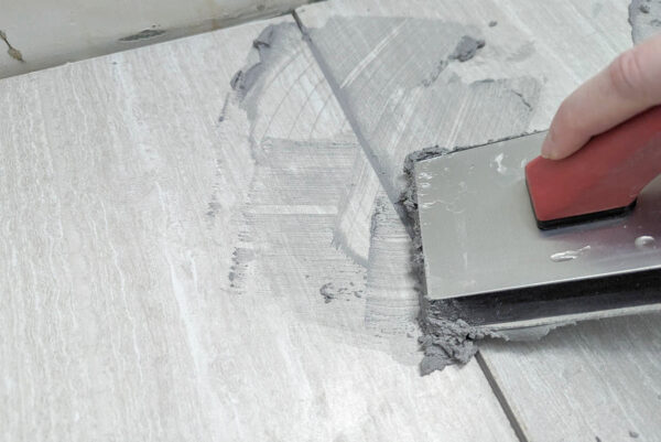close up of regrouting tile floor