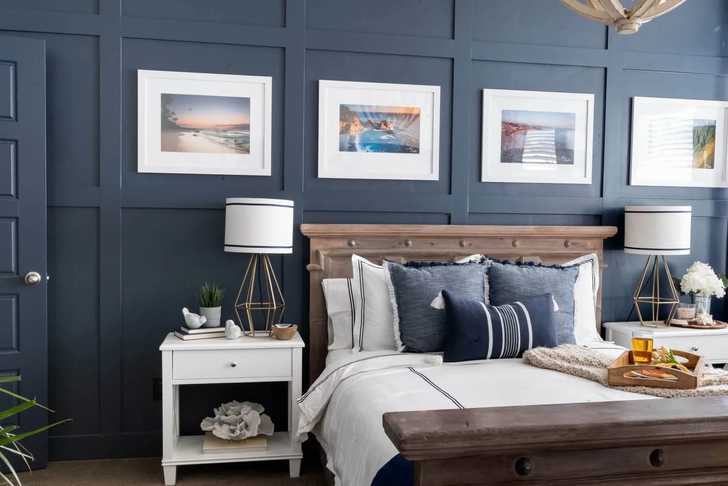 Dark blue painted wall with square board and batten behind bed.