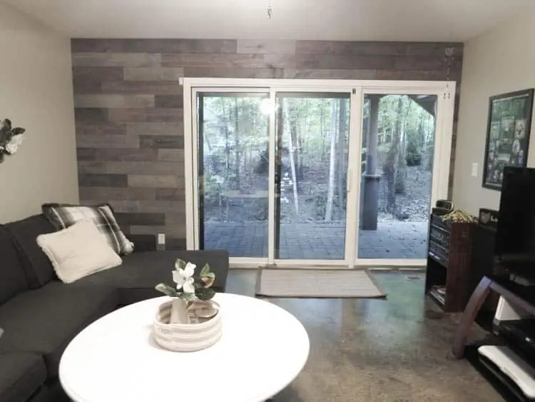 Living room with wood accent wall made from 4 inch pine wood planks.