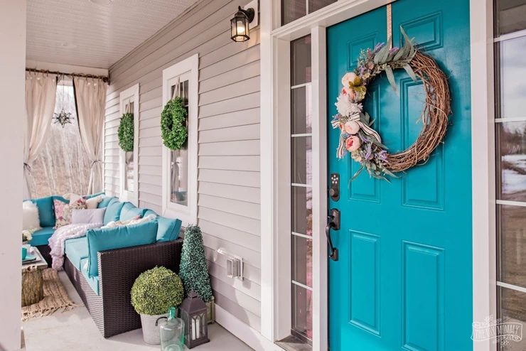 front porch with aqua front door.