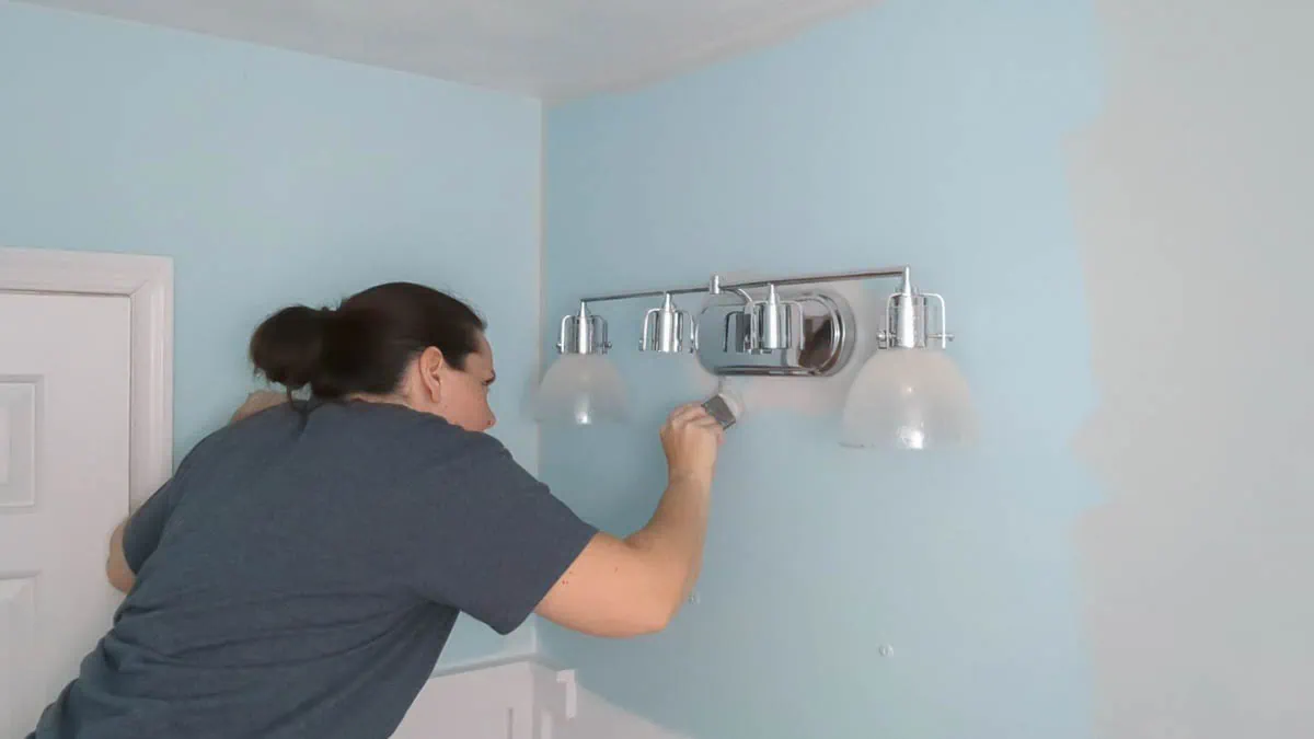cutting in around a light fixture when painting wall.