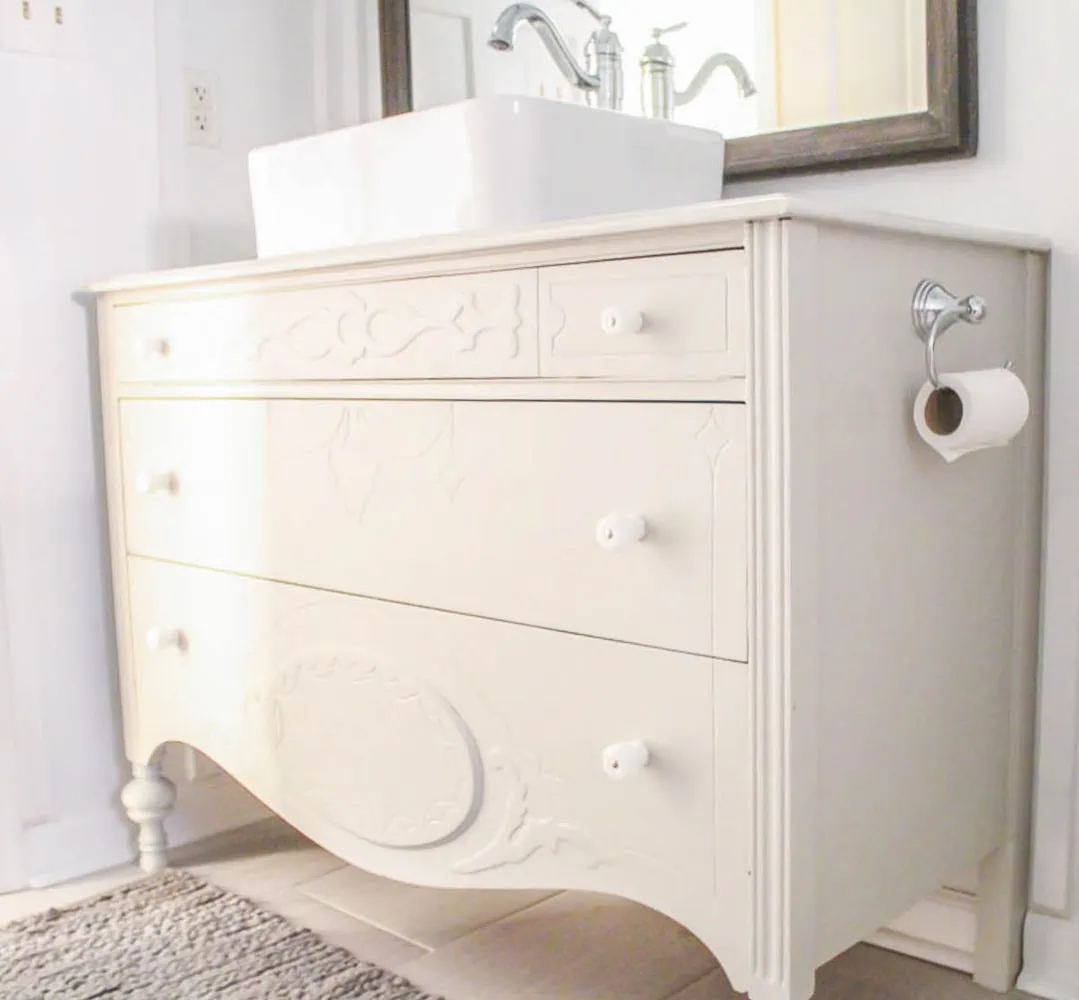 light gray dresser with vessel sink in bathroom.