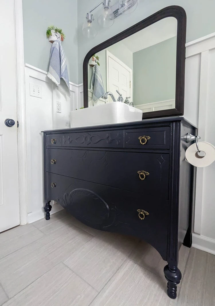 navy dresser vanity in bathroom.