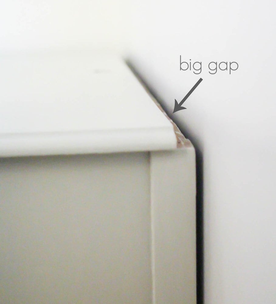 gap between back of old dresser and wall where mirror used to be.