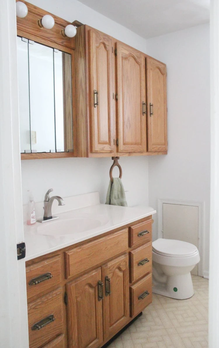 dated oak vanity in bathroom.