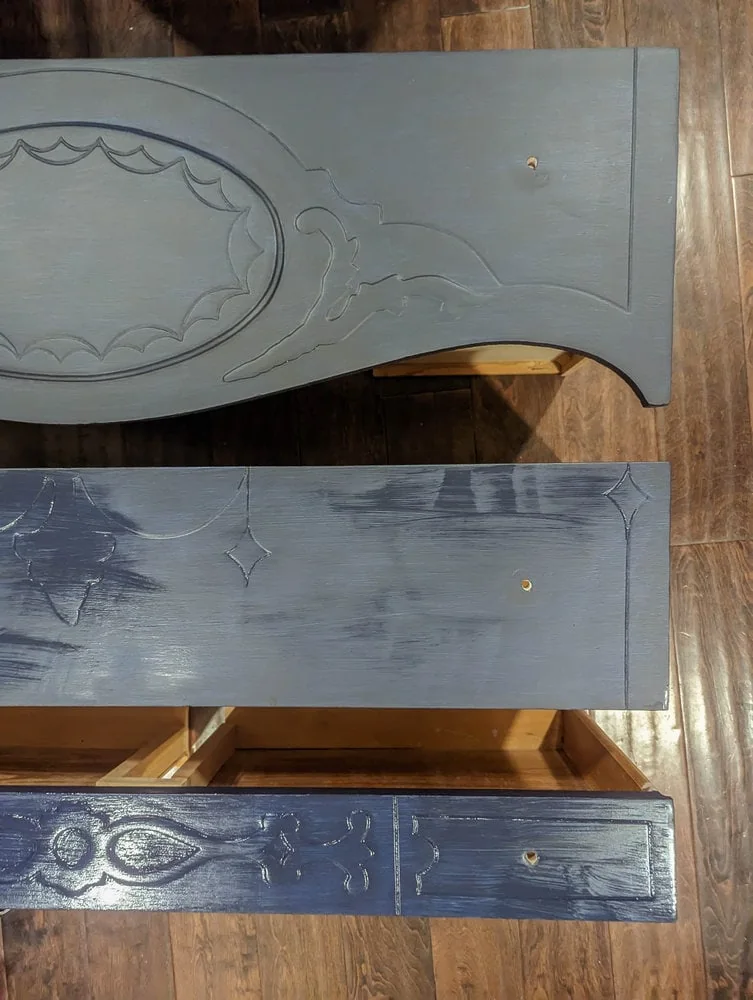 three drawers painted with general finishes milk paint in twilight showing how the paint darkens as it dries.