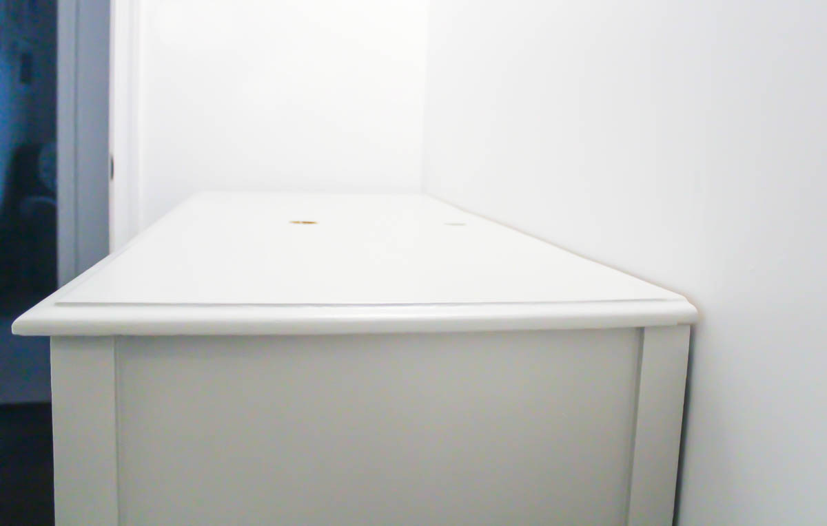 vintage dresser with the top now sitting flush against the wall, ready for a sink and faucet.
