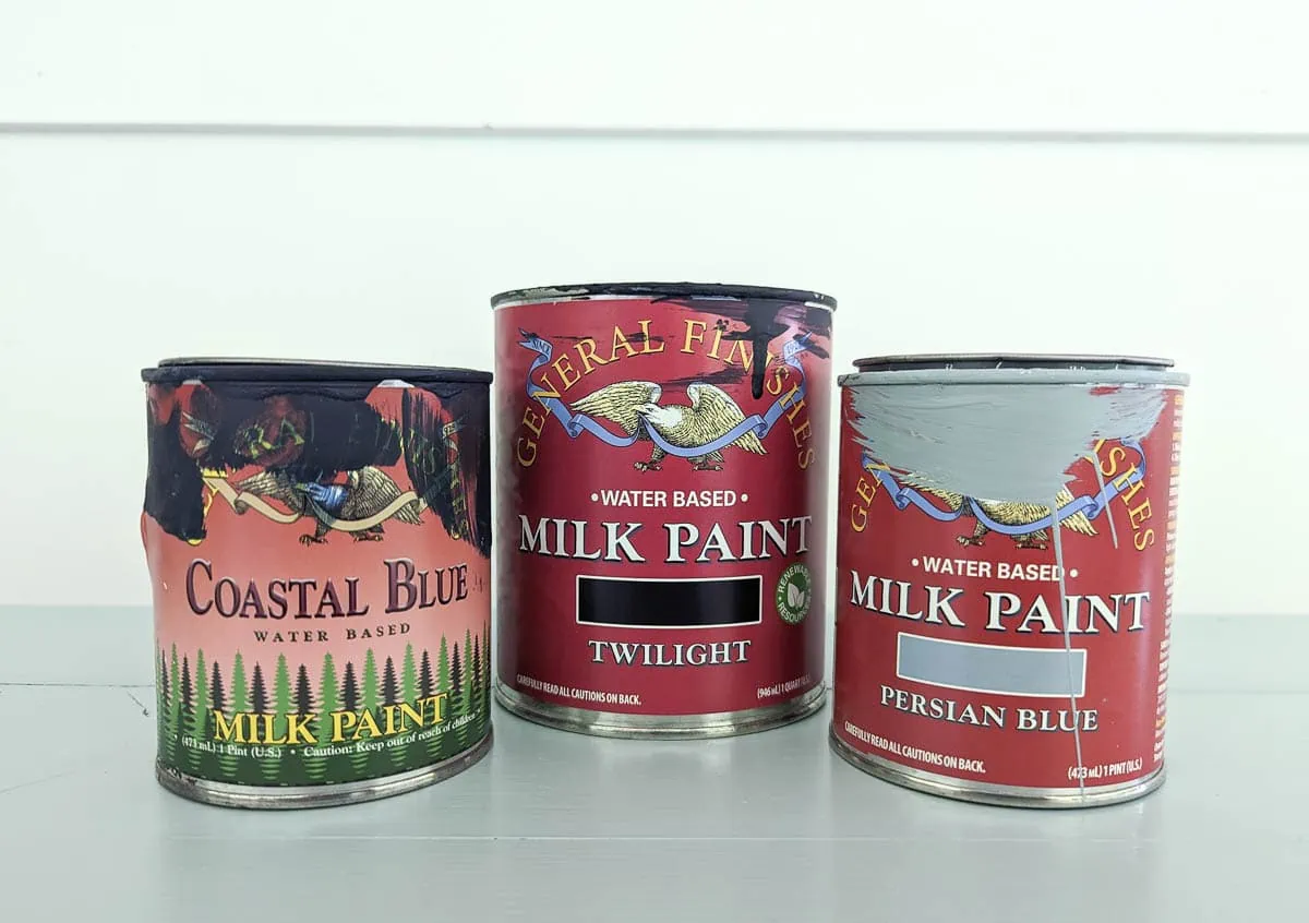 Three cans of general finishes milk paint.